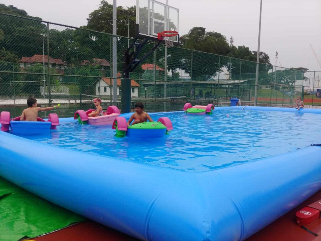 12m by 6m portable commercial PVC Inflatable Pool basin filled with water for paddle boats and roller drums in Singapore