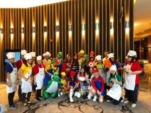 All-inclusive carnival event planner in Singapore setting up game stalls, bouncy castles, and live snack stations for school and community events