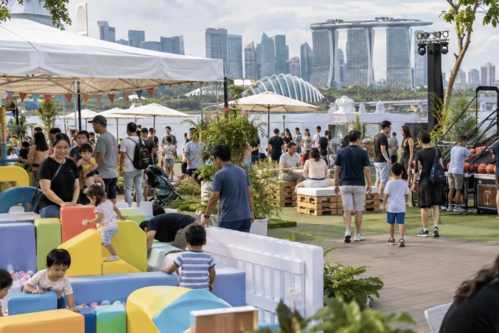 A Singapore corporate family day specialist organizes activity zones where children, parents, and adults enjoy games, soft play, and shared event spaces