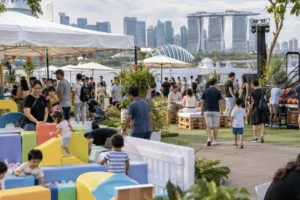 A Singapore corporate family day specialist organizes activity zones where children, parents, and adults enjoy games, soft play, and shared event spaces
